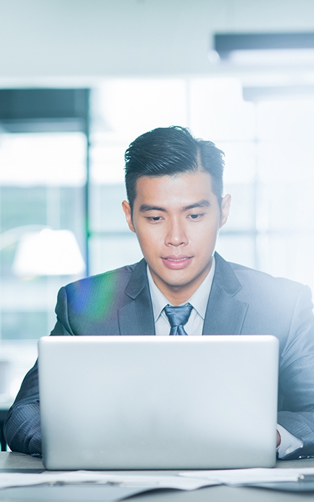 Portrait of young Asian businessman at work.