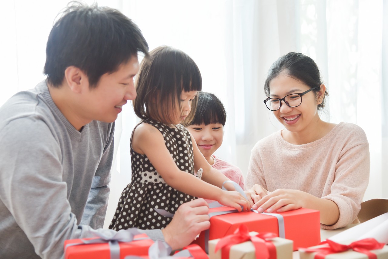 Happy family with kids opening gifts