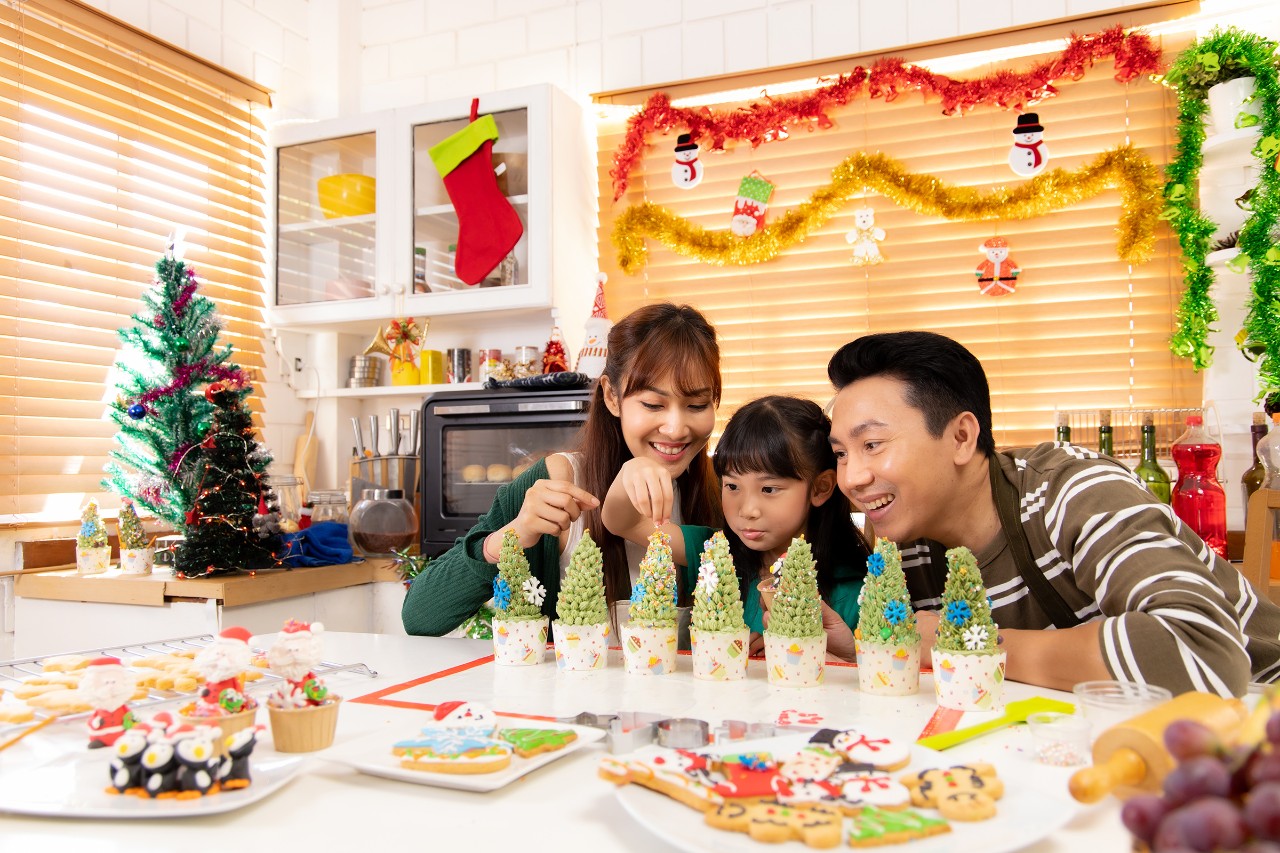 Happy family enjoys decorating for Christmas