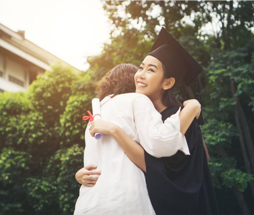 college graduate hugging mother